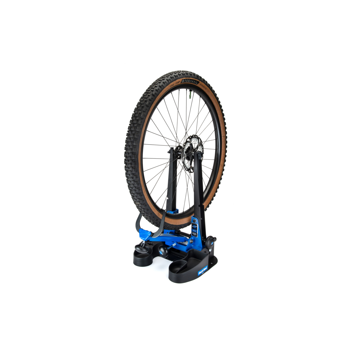 Park Tool TS-2.3 Powder Coated Blue Truing Stand with wheel with Tan Wall Terravail and Shimano icetech rotor sitting in it on white background