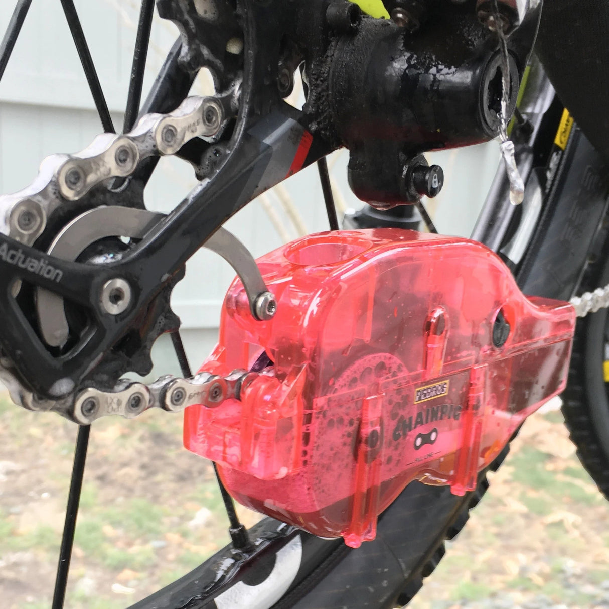 Rear view of Red Pedro's chain pig being used to clean a chain on a mountain bike with SRAM XX1 11 speed.