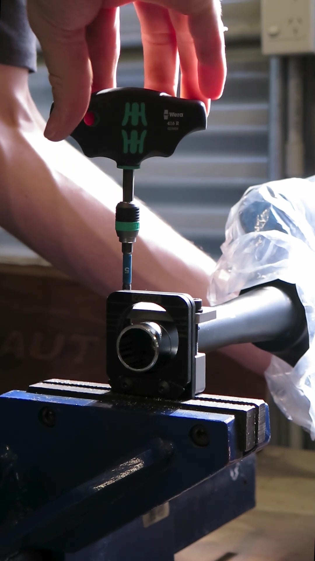 Cutting aluminium bicycle steerer tube with Pedro's Saw Guide in a blue vise.